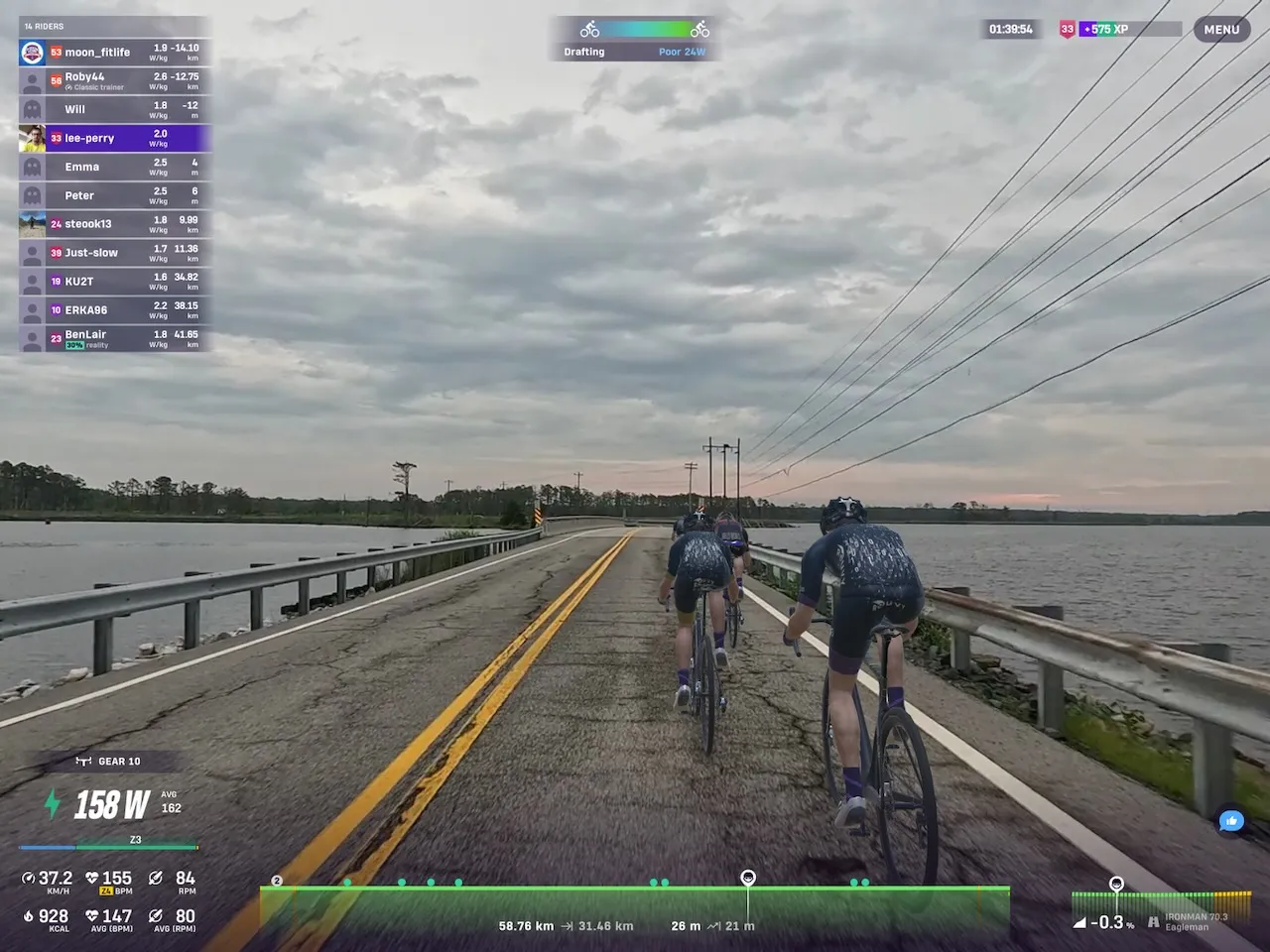 Riders avatars riding over a causeway in Rouvy, with the Blackwater River to either side.