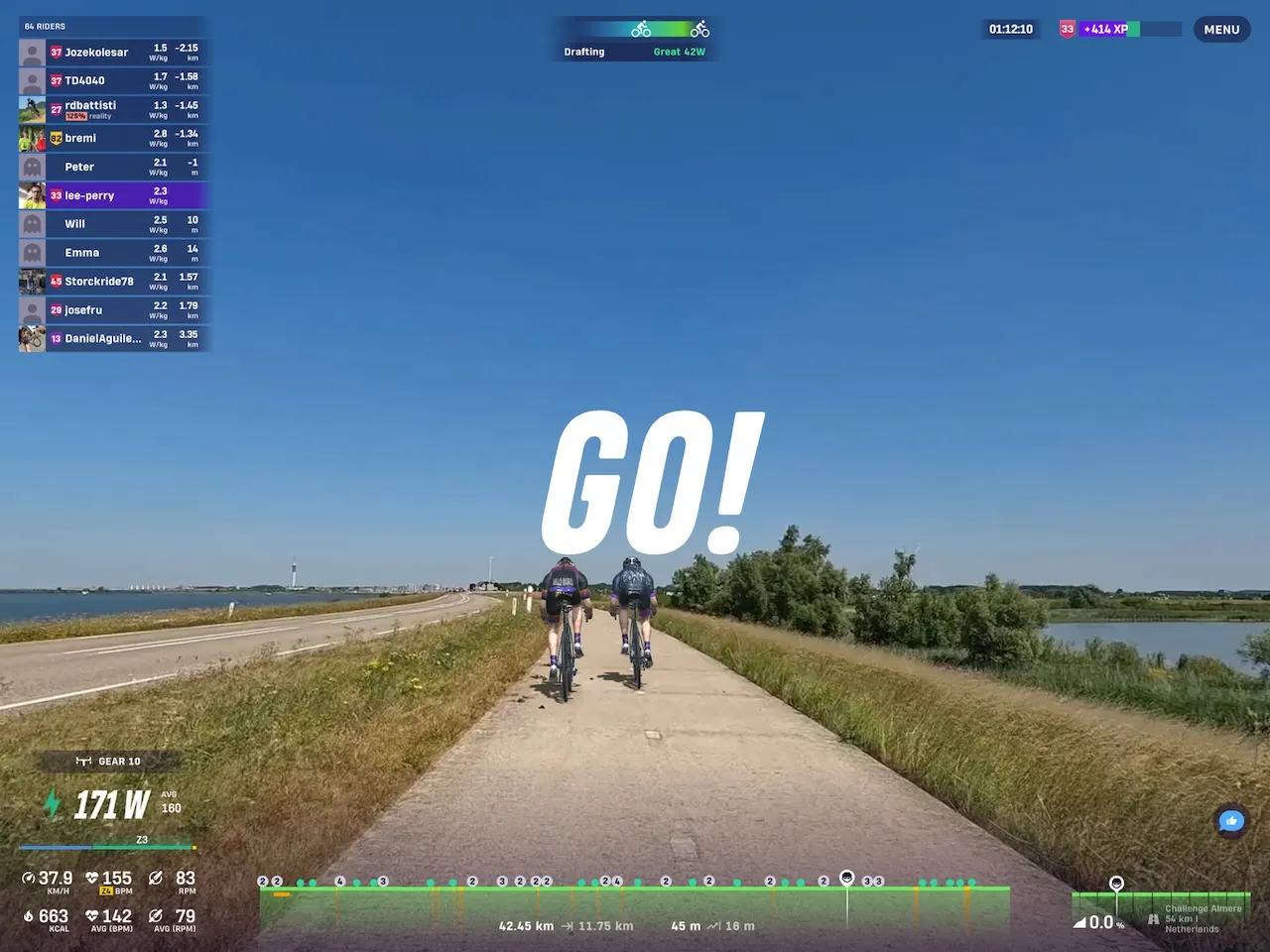 Riders avatars riding over a dyke Rouvy, with water to either side.