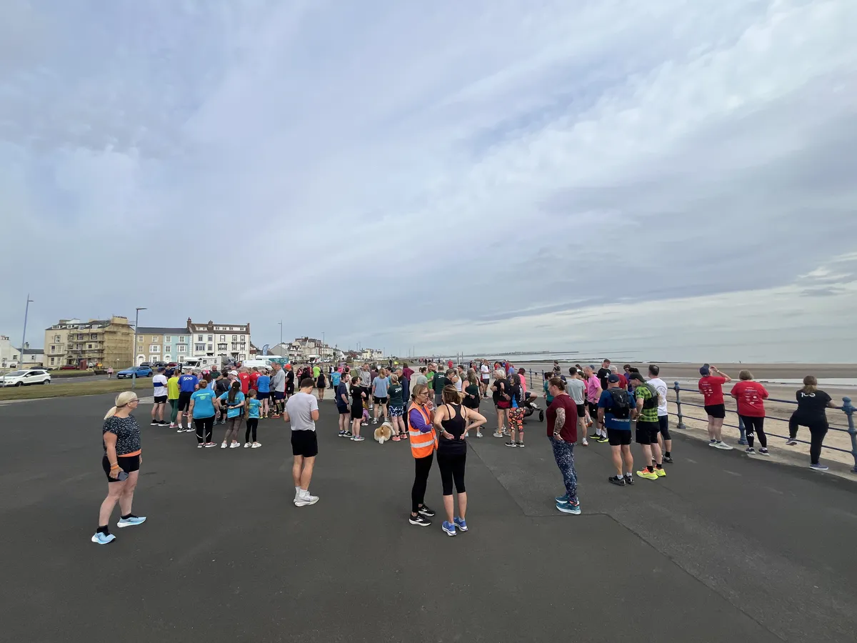 Looking along the course at Hartlepool Parkrun above participants at the start line on a clear day